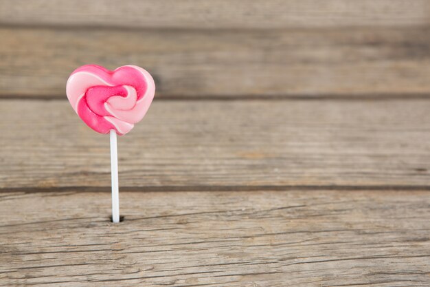 Photo close-up of pink heart shaped lollipop