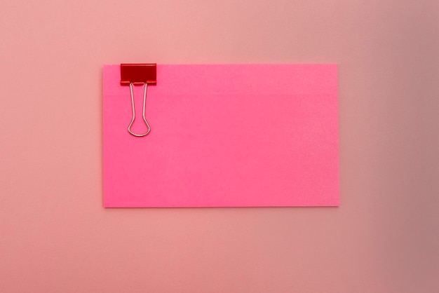 Close-up of pink paper hanging on wall