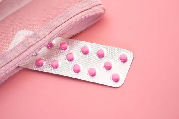 Photo close up of pink pills in a blister pack