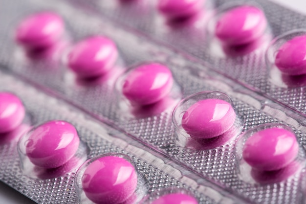 Close up of pink pills in plastic pack