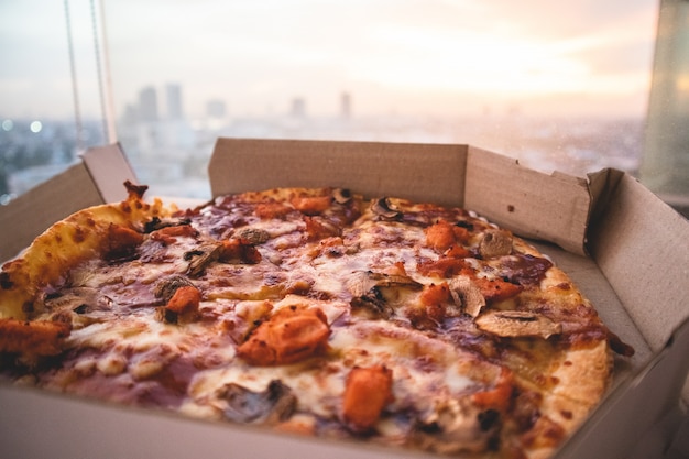 Close up of pizza and view of the city.