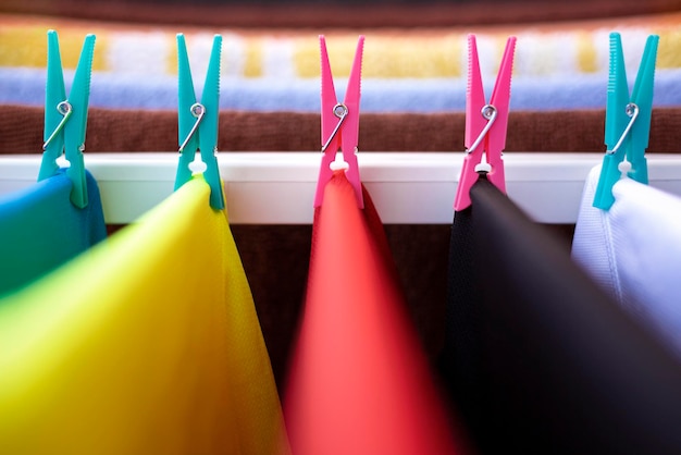 Close up of plastic clothespins of different colors. Clothes hanging. Selective focus, space for text.