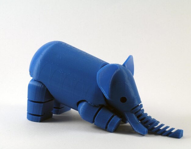 Photo close-up of plastic elephant toy against white background