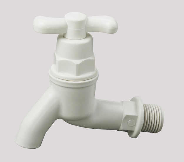 Photo close-up of plastic faucet against white background