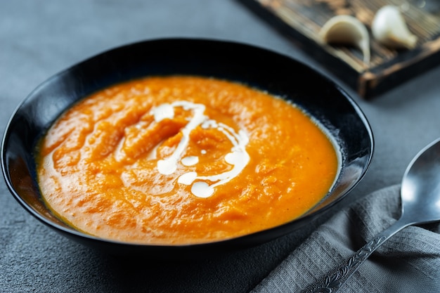 Close up of a plate with pumpkin soup