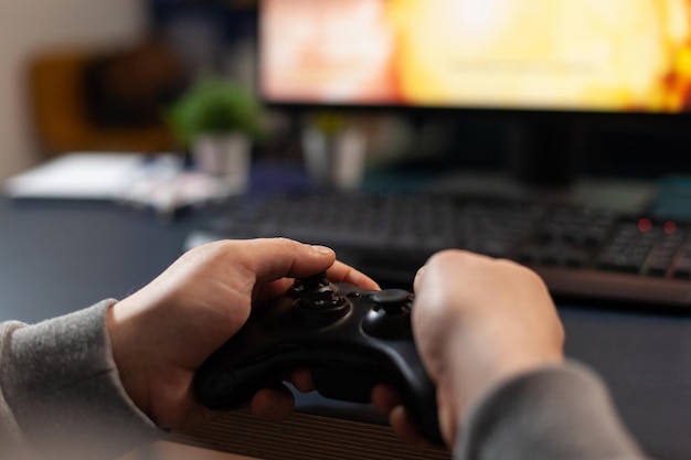 Premium Photo  Close up of player holding joystick, losing video games in  front of computer. gamer using joystick and playing online games on  monitor, sitting at desk. man gaming with modern