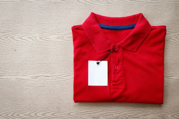 Close up polo shirt put on wooden tabletop
