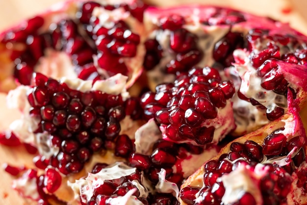 Close up of a pomegranate fruit cut into many pieces