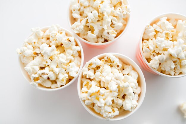 Photo close up of popcorn in disposable paper cups