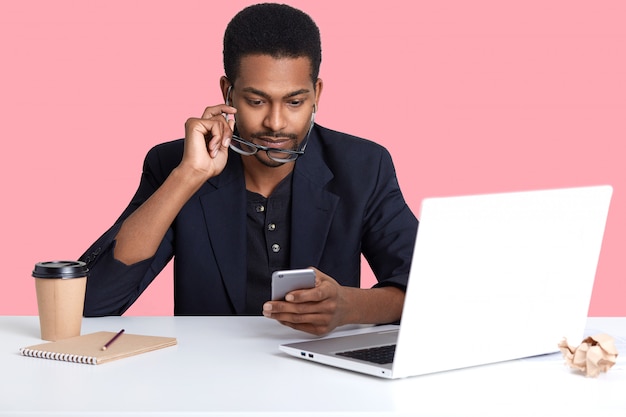 Close up portrait of African American businessman checked email on his smart phone