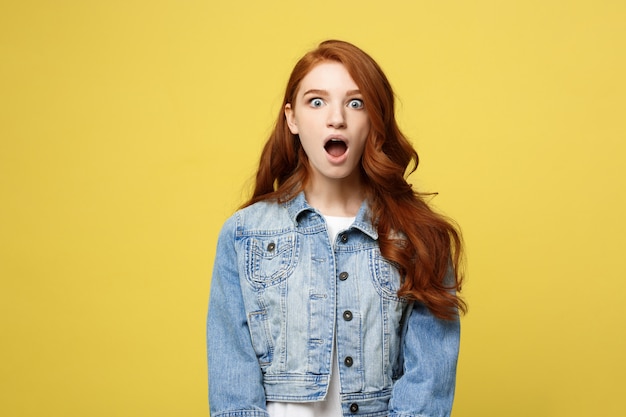 Close up Portrait amaze young beautiful attractive redhair girl shocking with something.