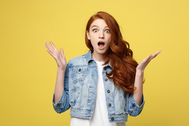 Close up Portrait amaze young beautiful attractive redhair girl shocking with something.