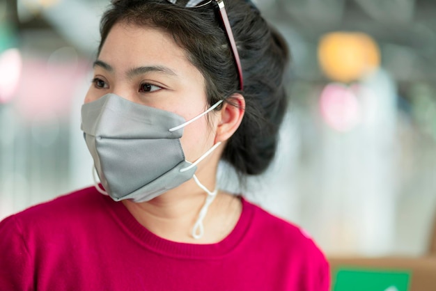 Close up portrait attractive female hand wear takeoff face mak protection safety travel concept new normal lifestyle at departure airport terminal