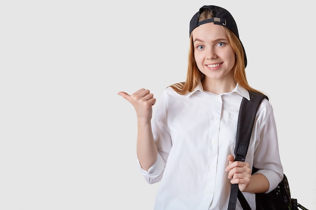 Close up portrait of attractive female student wearing cap