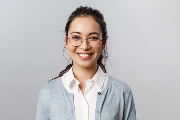 Close-up portrait of attractive, friendly-looking asian female office worke