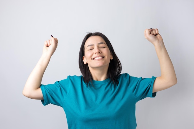 Close up portrait of attractive shouting in winning smiling with raised fists young she her girl