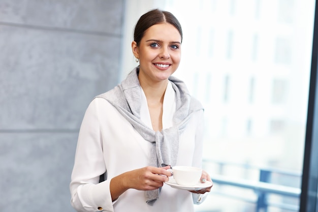 Close up portrait of attractive smiling businesswoman at workplace