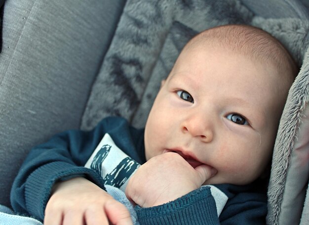 Photo close-up portrait of baby boy in stroller