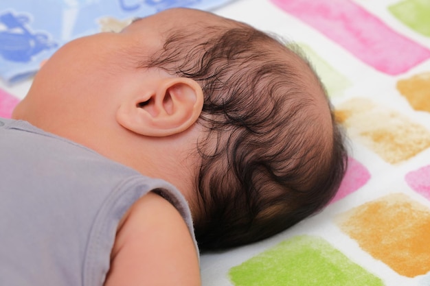 Photo close up portrait of baby ear and hair