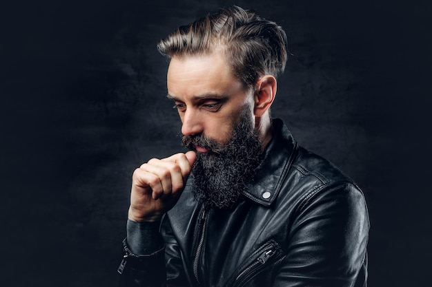 Close up portrait of bearded male wearing black leather jacket.