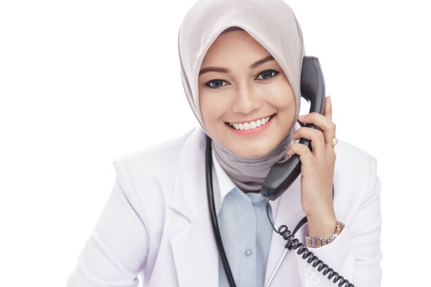 Close up portrait of beautiful asian female doctor talking on the phone