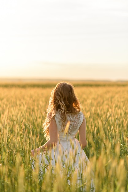 Close-up portrait of a beautiful bride. A woman looks into the distance and stands with his back to the camera.