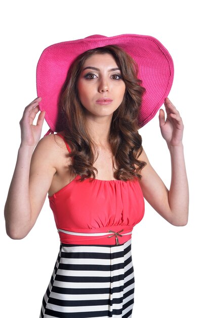 Close up portrait of beautiful brunette young woman in pink hat isolated on white background