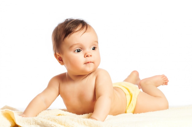 Close-up portrait of a beautiful curious half-year-old girl with big eyes on a white background