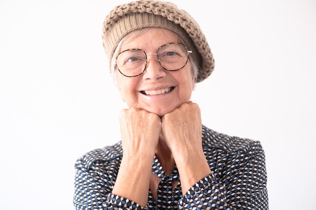 Close up portrait of beautiful elderly woman wearing glasses looking at camera smiling Short haired caucasian lady in modern shirt feeling in a good mood