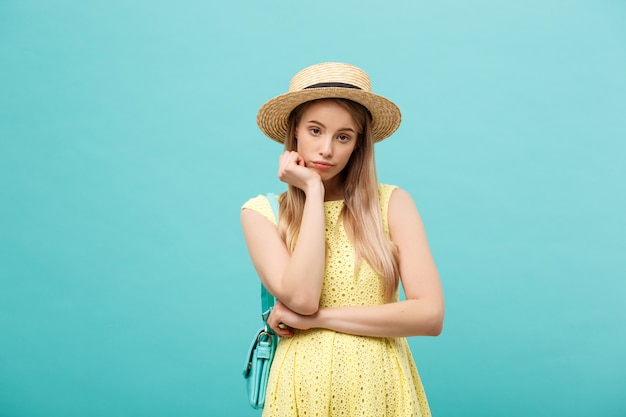 Close-up portrait of a beautiful girl bored with something, wearing a hat