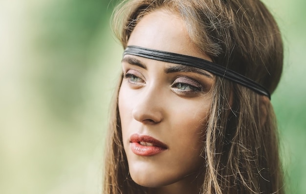 Close up. portrait of beautiful hippie girl on blurred background