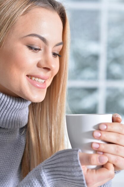 Close up portrait of beautiful woman drinking tea