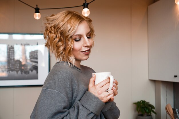 Close-up portrait of a beautiful woman with cup of coffee