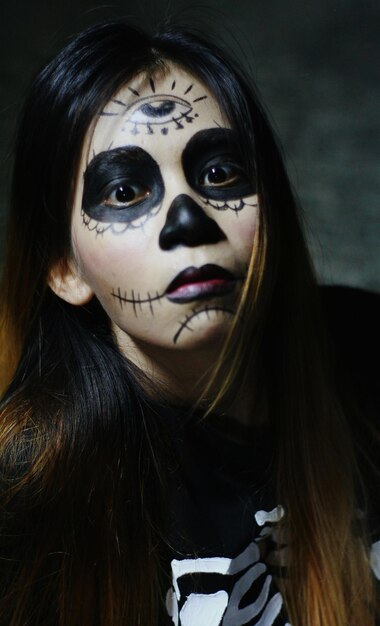 Close-up portrait of beautiful woman with face paint during halloween