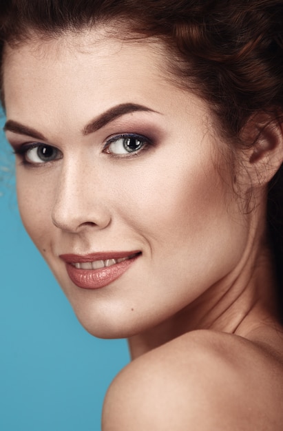 Close-up portrait of a beautiful woman with a smile.