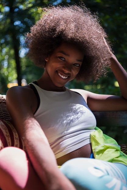 Close up portrait of a beautiful young african american woman smiling and looking up on a beautiful sunny day