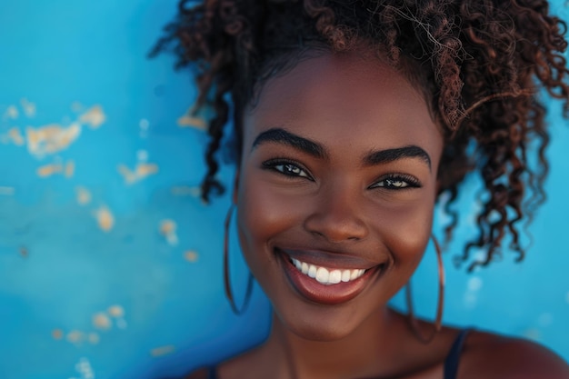 Close up portrait of beautiful young black woman smiling against blue background