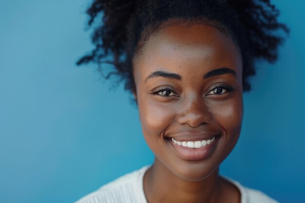 Close up portrait of beautiful young black woman smiling against blue background