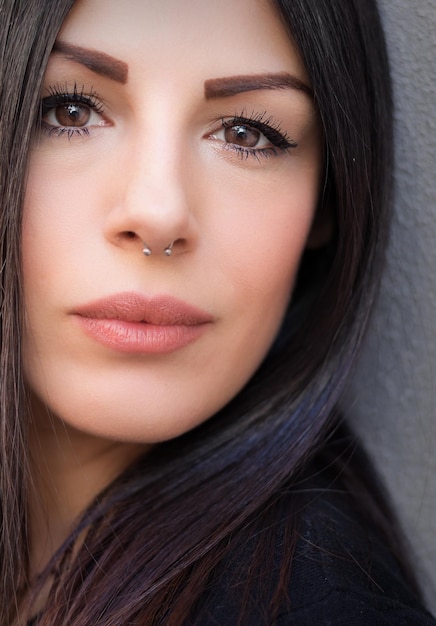 Photo close-up portrait of beautiful young woman by wall