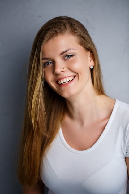 Close up portrait of a beautiful young woman. Emotional photo of a girl. Dressed in a white t-shirt