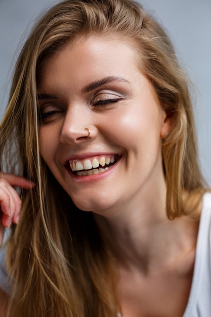 Close up portrait of a beautiful young woman. Emotional photo of a girl. Dressed in a white t-shirt