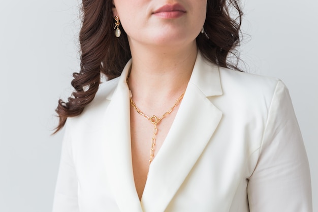 Close-up portrait of beautiful young woman with elegant hairstyle and luxurious jewelry