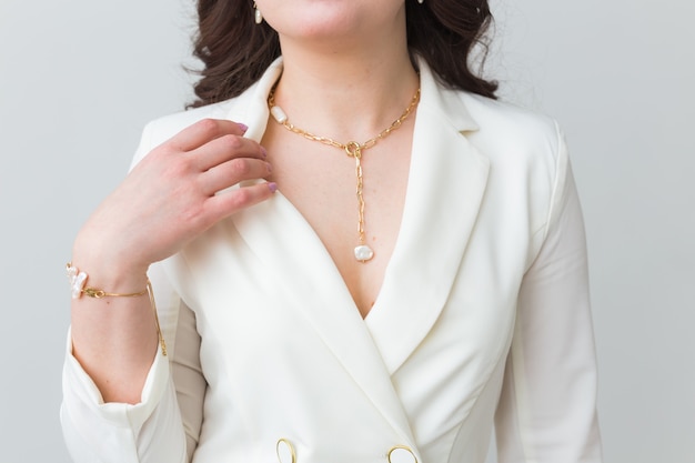 Close-up portrait of beautiful young woman with elegant hairstyle and luxurious jewelry