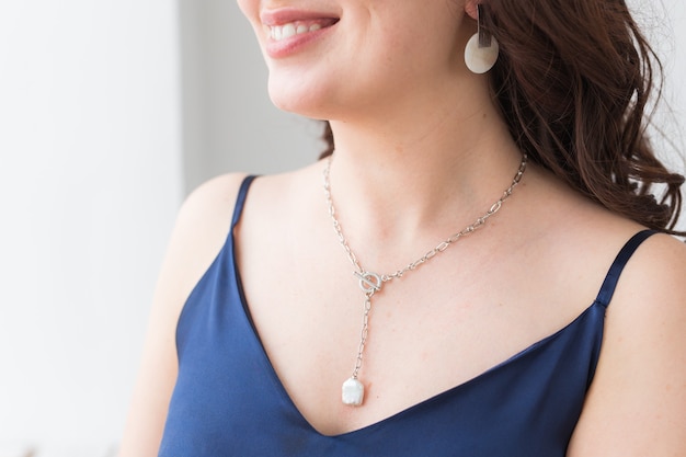 Close-up portrait of beautiful young woman with elegant luxurious jewelry and bijouterie