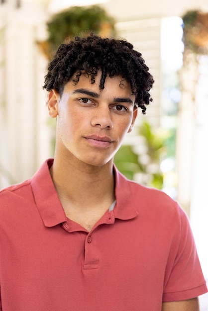 Photo close-up portrait of biracial young man with dreadlocks looking at camera at home, copy space. unaltered, lifestyle, serious, handsome and home concept.