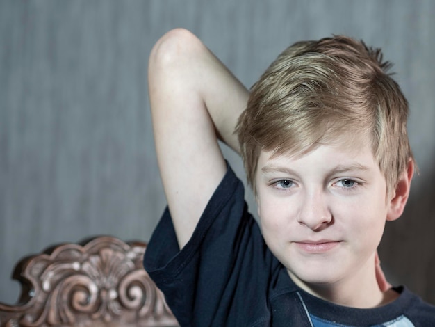 Close-up portrait of boy against wall