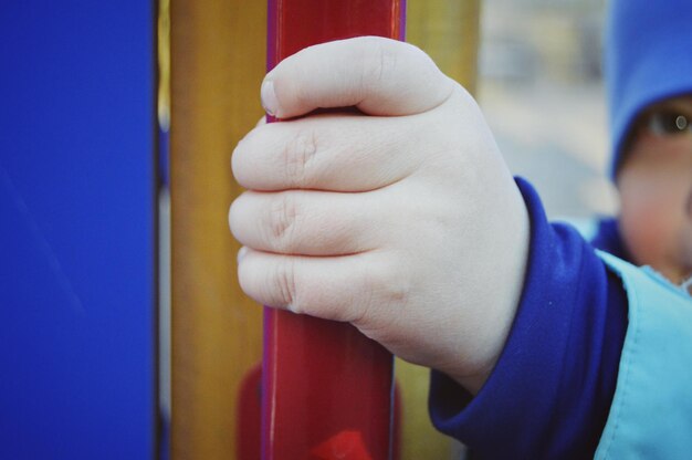 Close-up portrait of boy holding pole