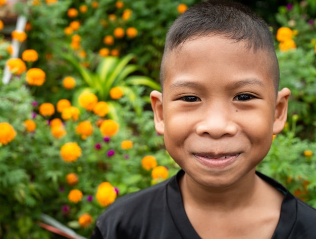 Close up on portrait of boy smiling in nature