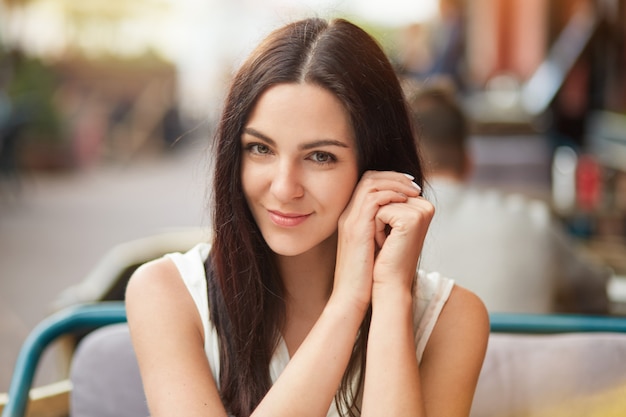 Close up portrait of brunette satisfied young female model