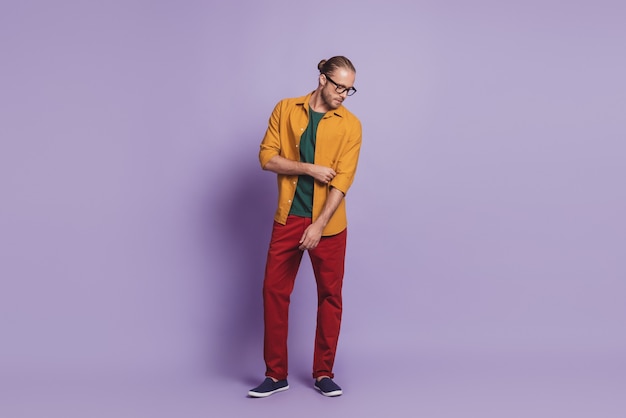 Close up portrait of business man guy posing hands pockets on violet wall